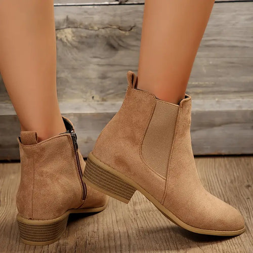 Tan brushed-finish Chelsea boots with elastic side gores, side zippers, and low stacked heels on a rounded toe silhouette.