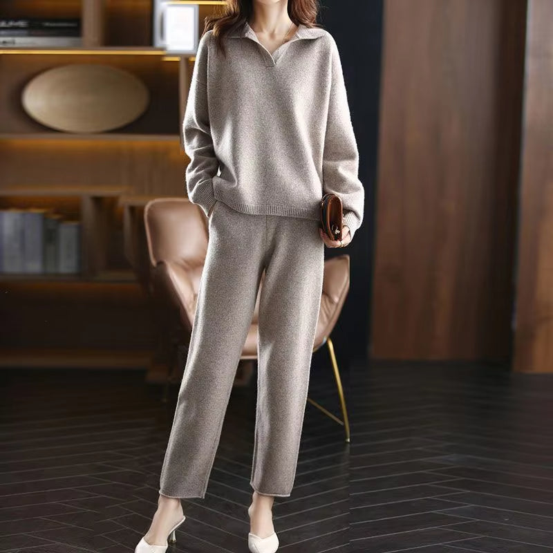 Beige collared V-neck sweater with ribbed cuffs and matching straight-cut knit trousers in a soft, textured fabric.
