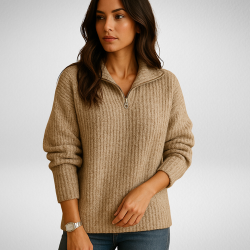 Beige ribbed knit half-zip sweater with a funnel collar and tailored fit worn with blue jeans.