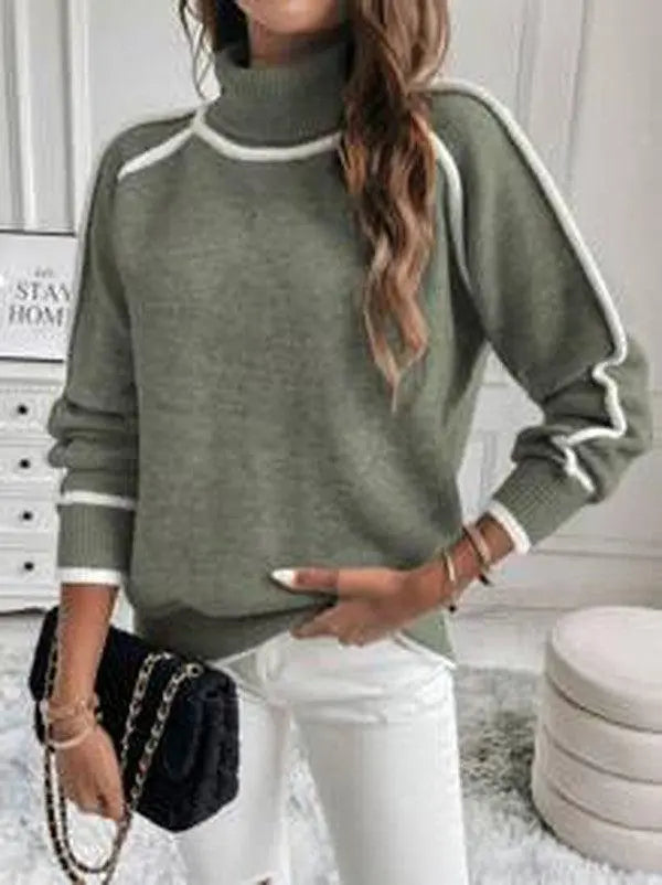 Olive green turtleneck sweater with white contrast piping, ribbed cuffs, and a soft knit texture worn with white jeans.