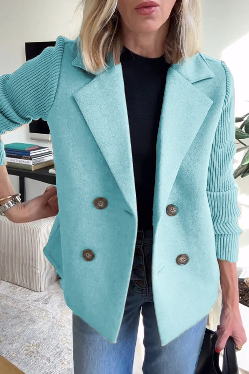 Teal wool-blend double-breasted blazer with contrasting ribbed-knit sleeves and a tailored, structured fit.