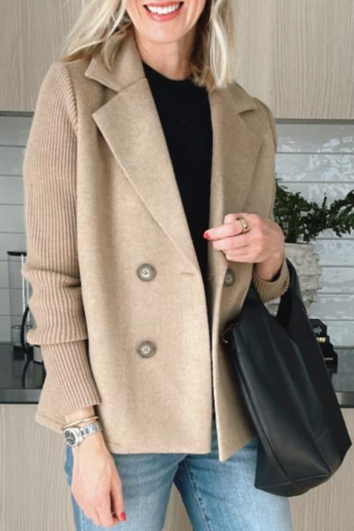 Tan wool-blend double-breasted blazer with contrasting ribbed-knit sleeves and a tailored, structured fit.
