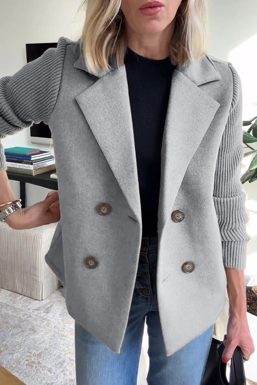 Grey wool-blend double-breasted blazer featuring structured lapels and contrasting ribbed-knit sleeves.
