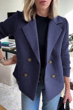 Navy blue double-breasted wool blend blazer with contrasting ribbed-knit sleeves and a tailored structured fit.