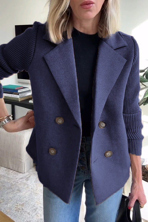 Navy blue double-breasted wool blend blazer with contrasting ribbed-knit sleeves and a tailored structured fit.