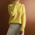 Yellow wool turtleneck sweater featuring a raised diamond-pattern knit, ribbed cuffs, and a relaxed, comfortable fit.