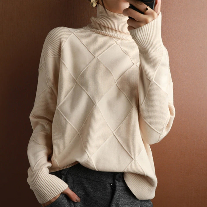 Cream wool turtleneck sweater featuring a raised diamond-pattern knit, ribbed collar, and cuffs in a relaxed fit.