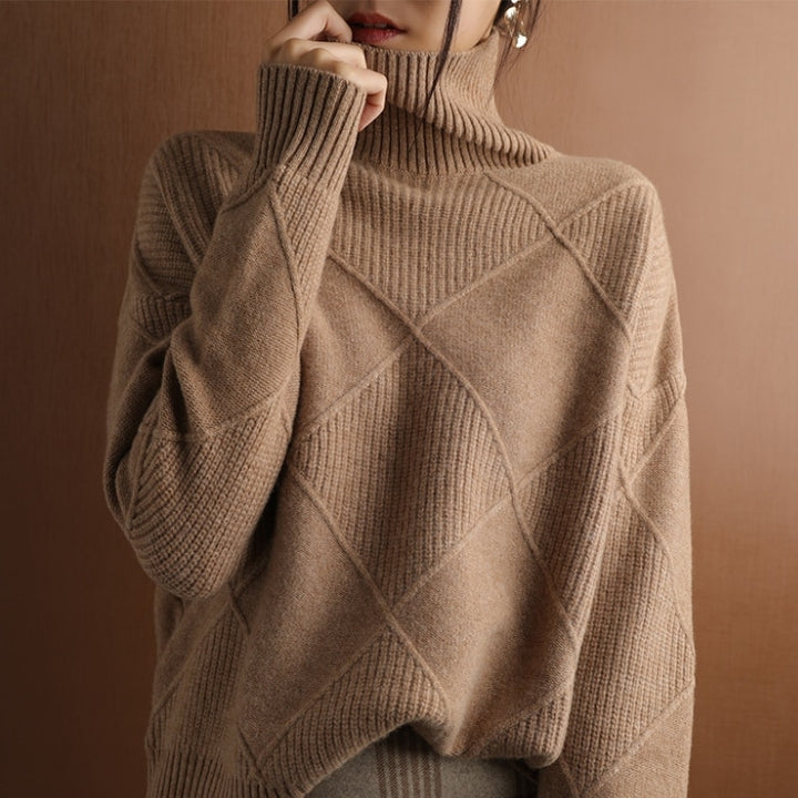 Tan wool turtleneck sweater featuring a raised diamond-pattern knit, high ribbed collar, and structured ribbed cuffs.