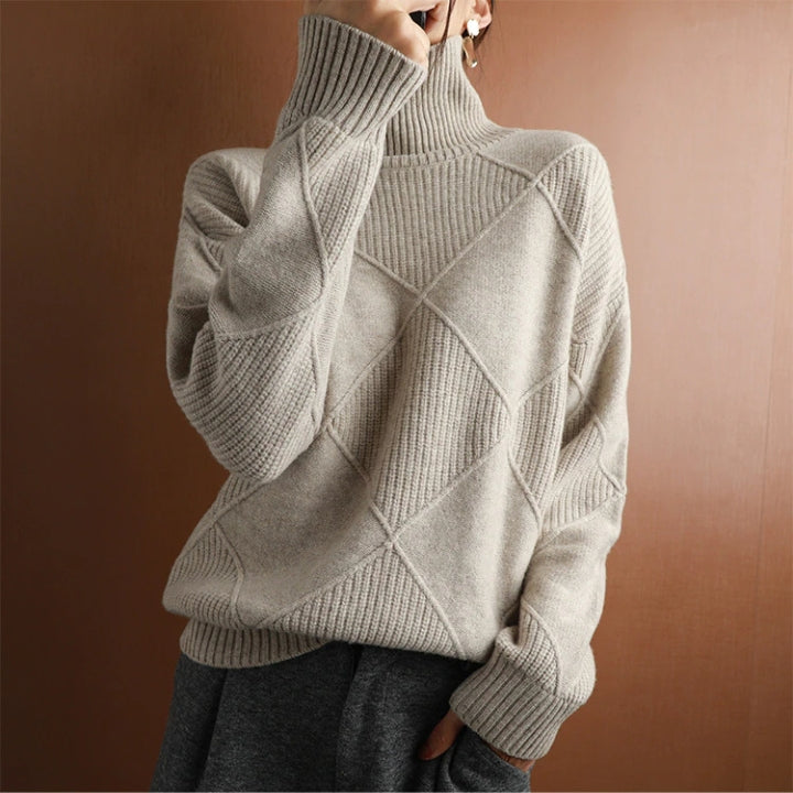 Beige wool turtleneck sweater featuring a raised diamond-pattern knit, ribbed high collar, and cuffed sleeves.