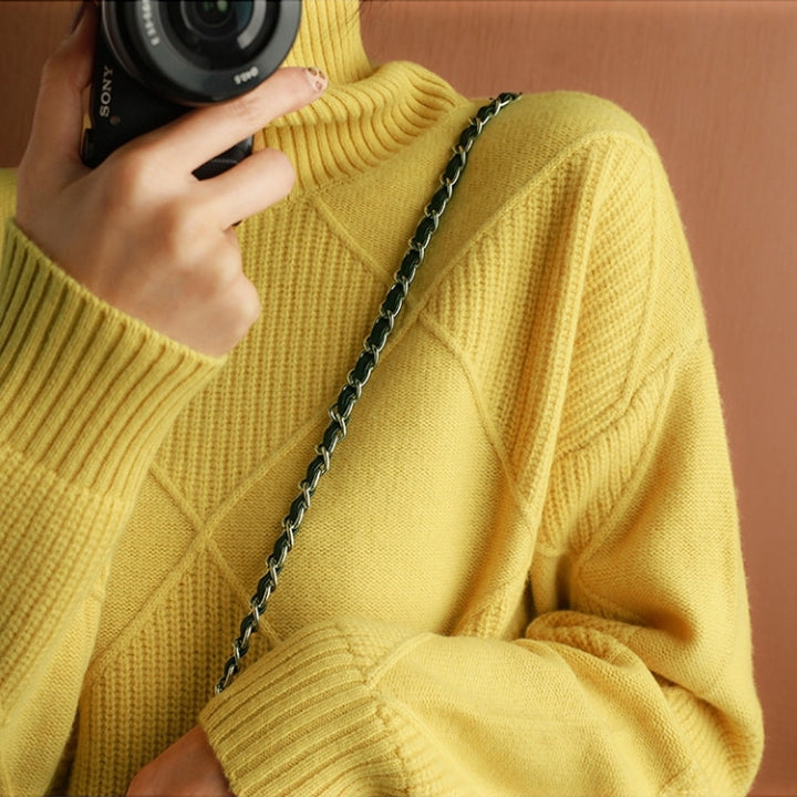 Yellow wool turtleneck sweater featuring a raised diamond-pattern knit, ribbed cuffs, and a high collar.