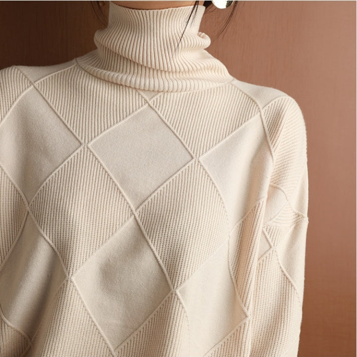 Cream wool turtleneck sweater featuring a raised diamond-pattern knit texture and structured ribbed collar.