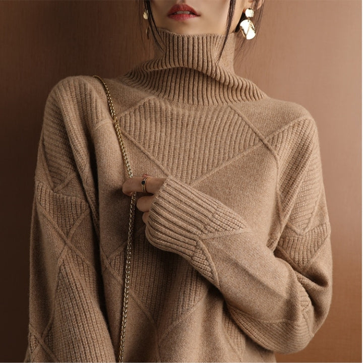 Tan wool turtleneck sweater featuring a raised diamond-pattern knit, ribbed high collar, and structured cuffs.