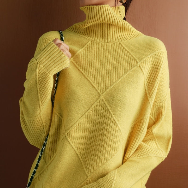 Yellow wool turtleneck sweater featuring a raised diamond-pattern knit, ribbed collar, and cuffs in a relaxed fit.