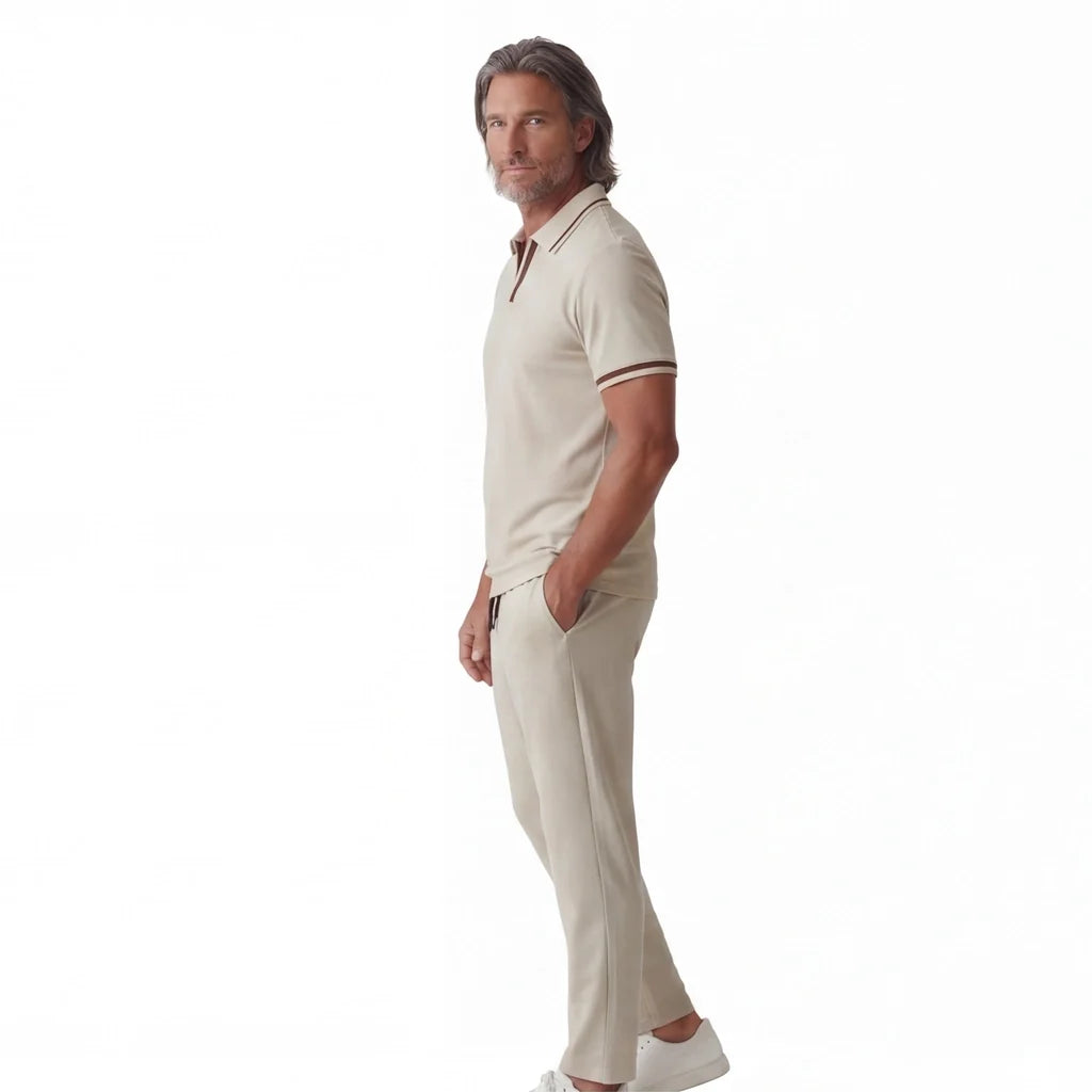 Side view of a man wearing a cream short-sleeve polo shirt paired with matching drawstring pants.