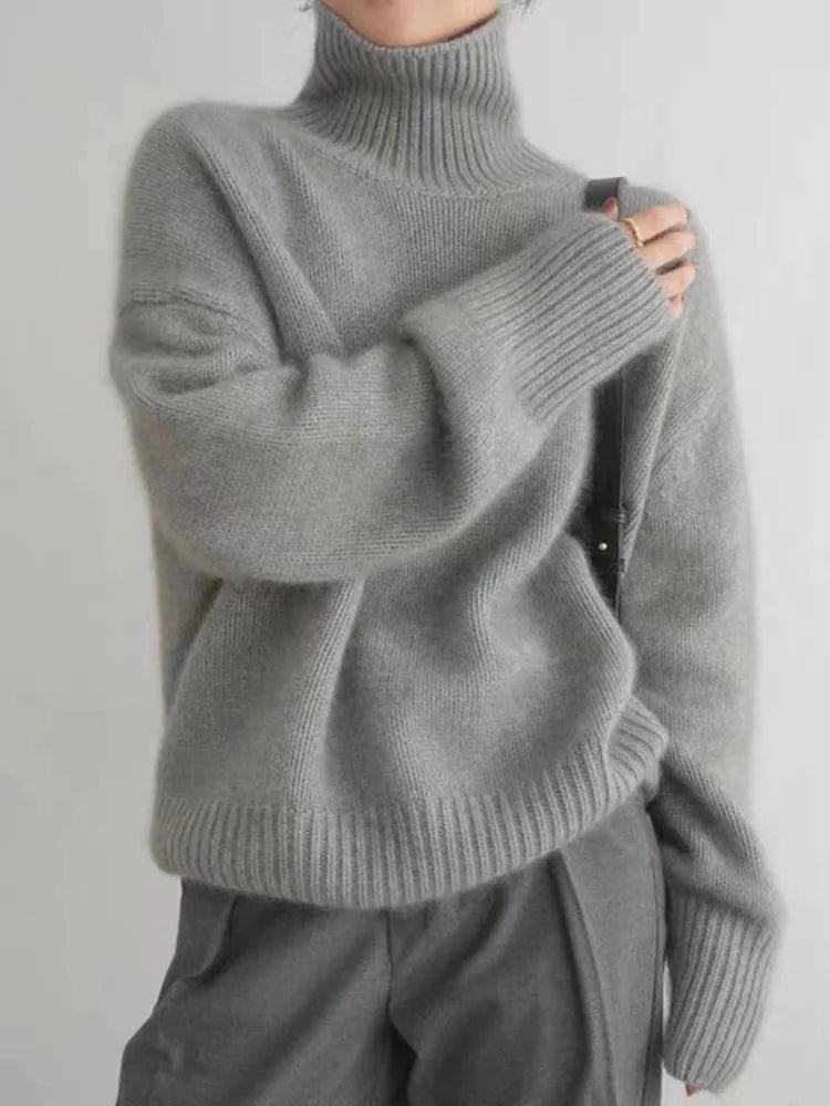 Grey brushed knit turtleneck sweater in an oversized fit with ribbed cuffs and a high collar.