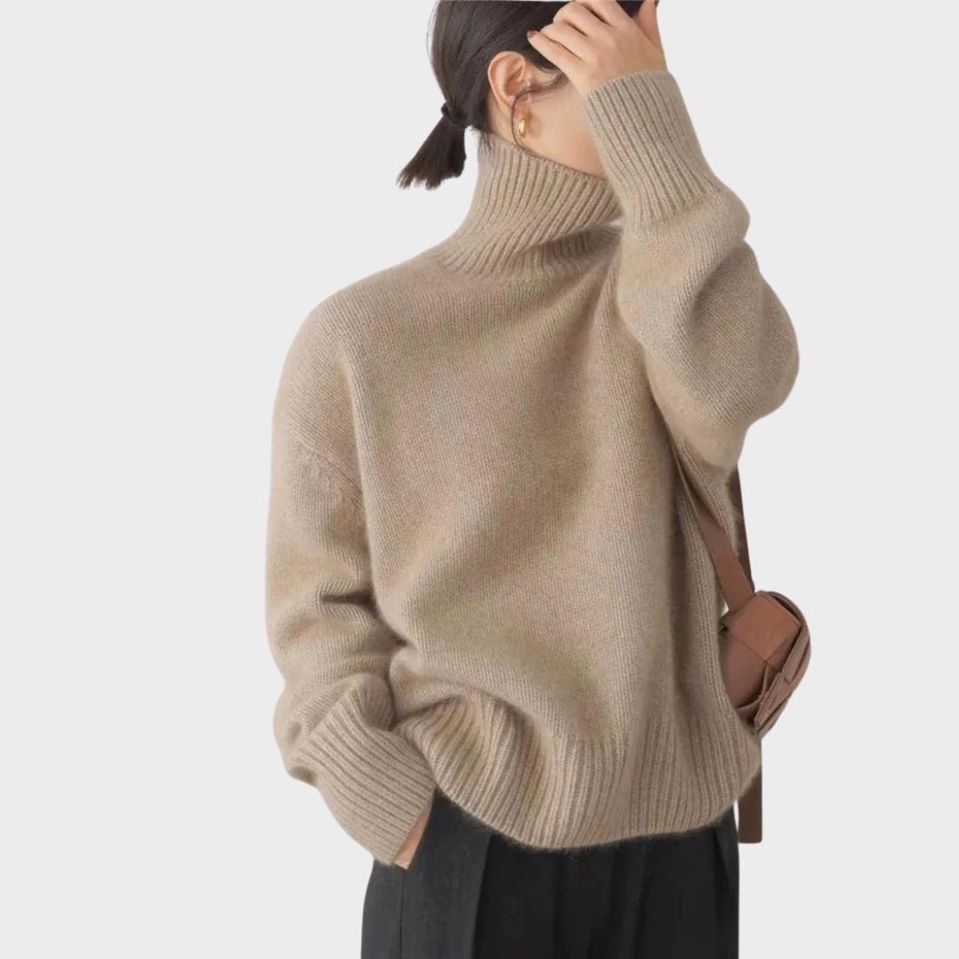 Beige brushed knit turtleneck sweater with a relaxed oversized fit, high collar, and ribbed cuffs.