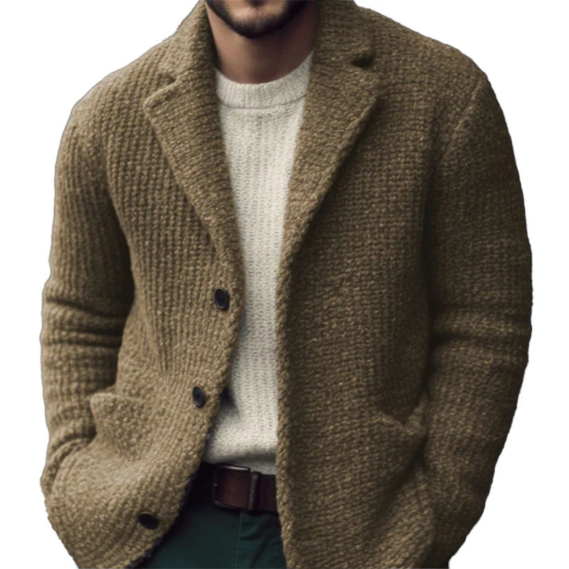 Olive green textured knit cardigan with a notch collar, front button closure, and patch pockets over a cream sweater.