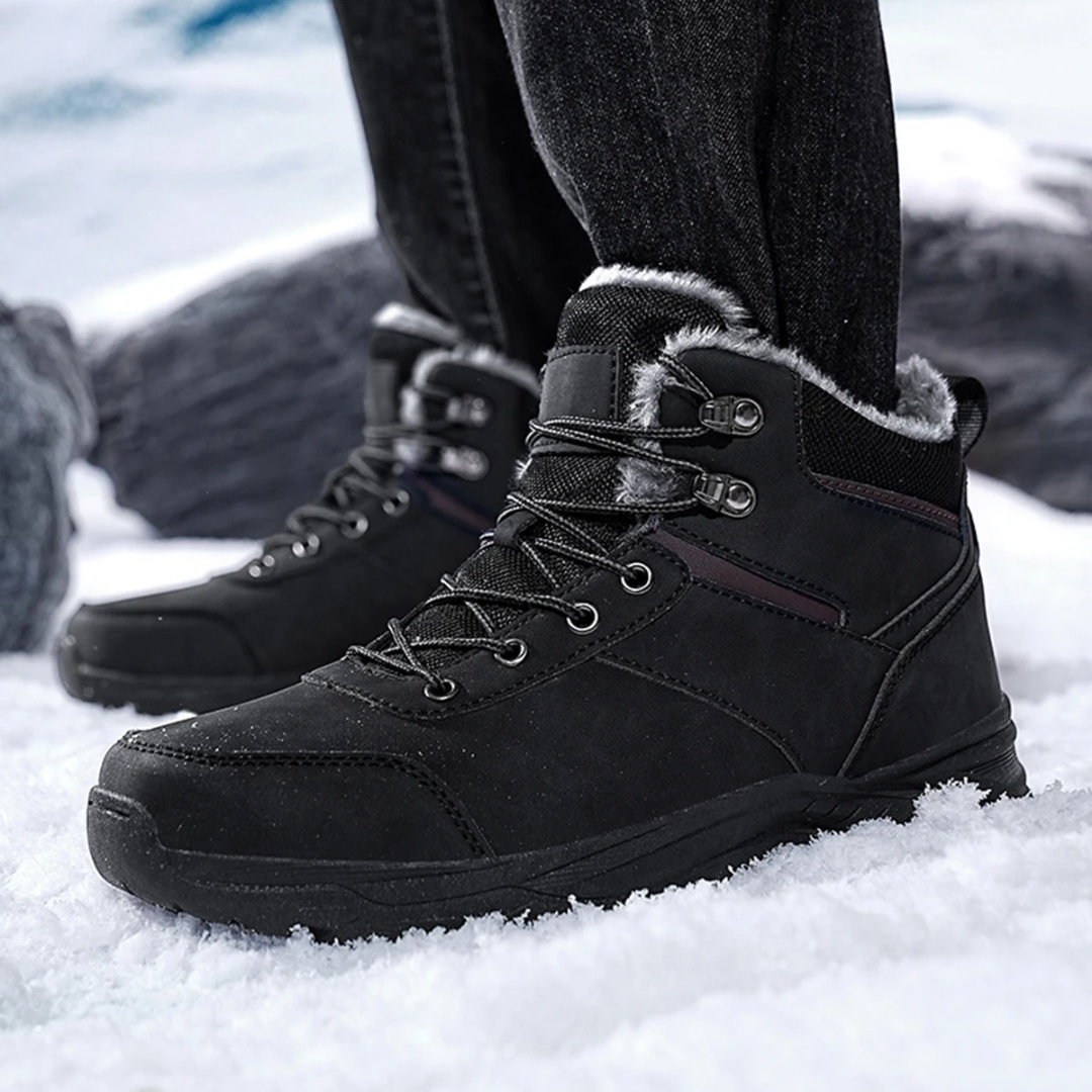 Black vegan leather ankle snow boots for men with fleece collar and lug sole, worn in the snow