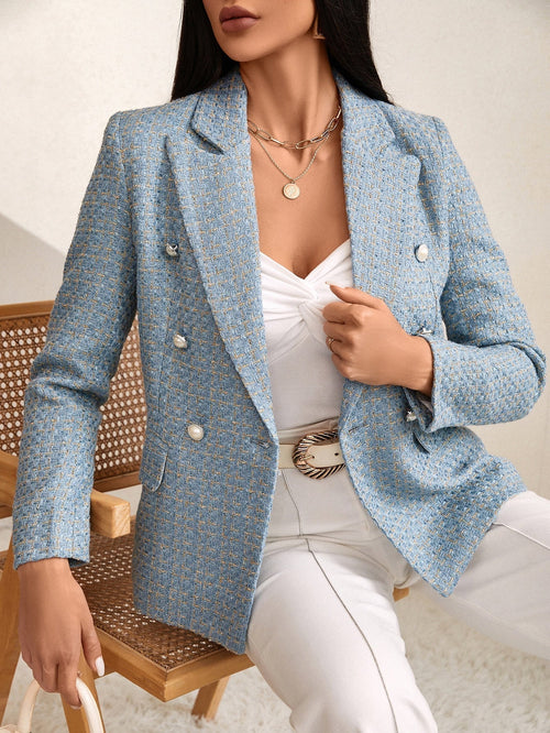Blue tweed double-breasted blazer with notched lapels and decorative buttons, worn over a white top and trousers.