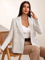 White tweed double-breasted blazer with notched lapels, accent buttons, and a tailored fit worn over a white top.
