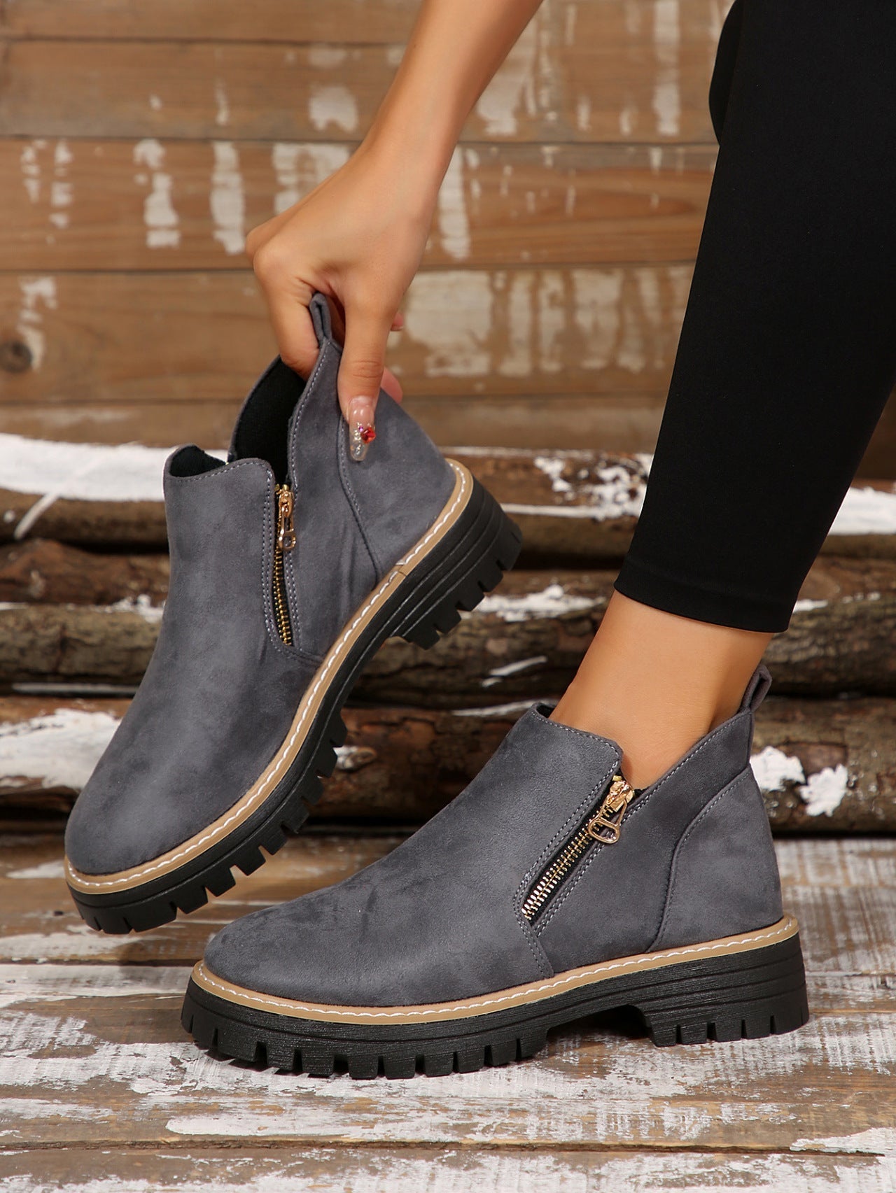 Grey brushed-finish ankle boots with side zips, round toes, and chunky notched tread platform soles.