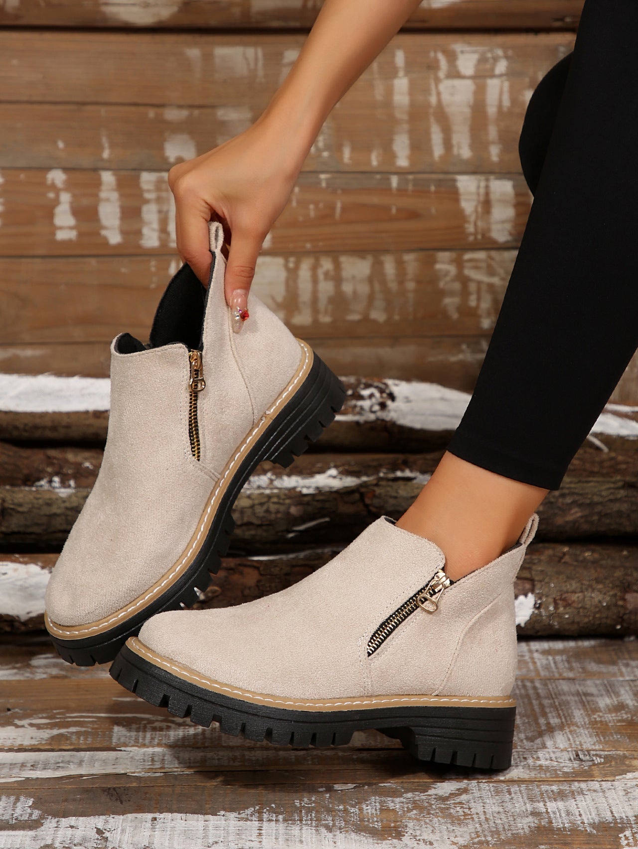 Beige brushed ankle boots with side zips, round toes, and chunky black notched tread platform soles.