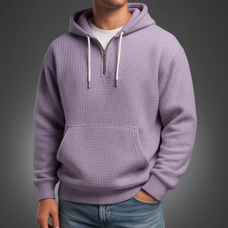 Lavender waffle knit pullover hoodie with a kangaroo pocket, adjustable drawstrings, and a relaxed fit, worn with blue jeans.