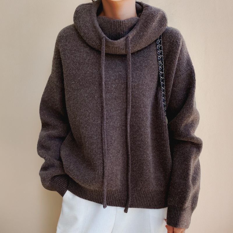 Oversized dark brown ribbed knit hooded sweater with a drawstring cowl neck, dropped shoulders, and a ribbed hem.