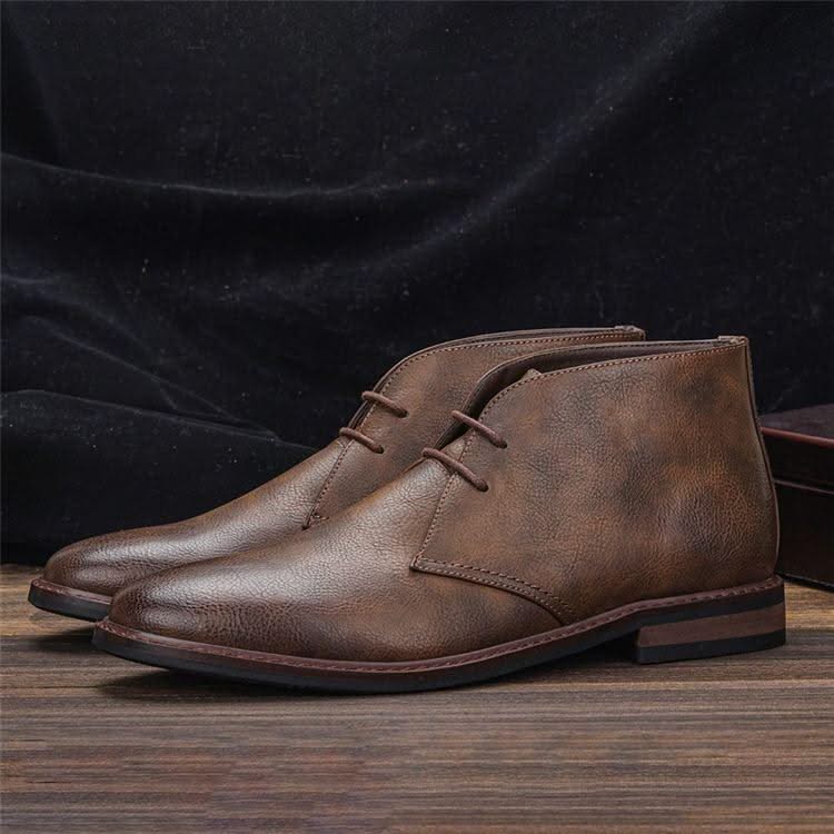 Brown grained leather chukka boots with three-eyelet lacing, stitched welt detail, and a low stacked block heel.