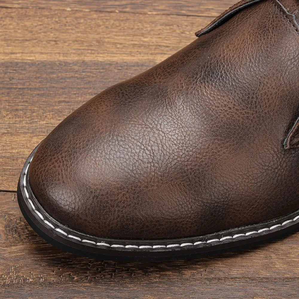 Brown grained leather chukka boot featuring a clean toe line, visible white welt stitching, and a durable low block heel.