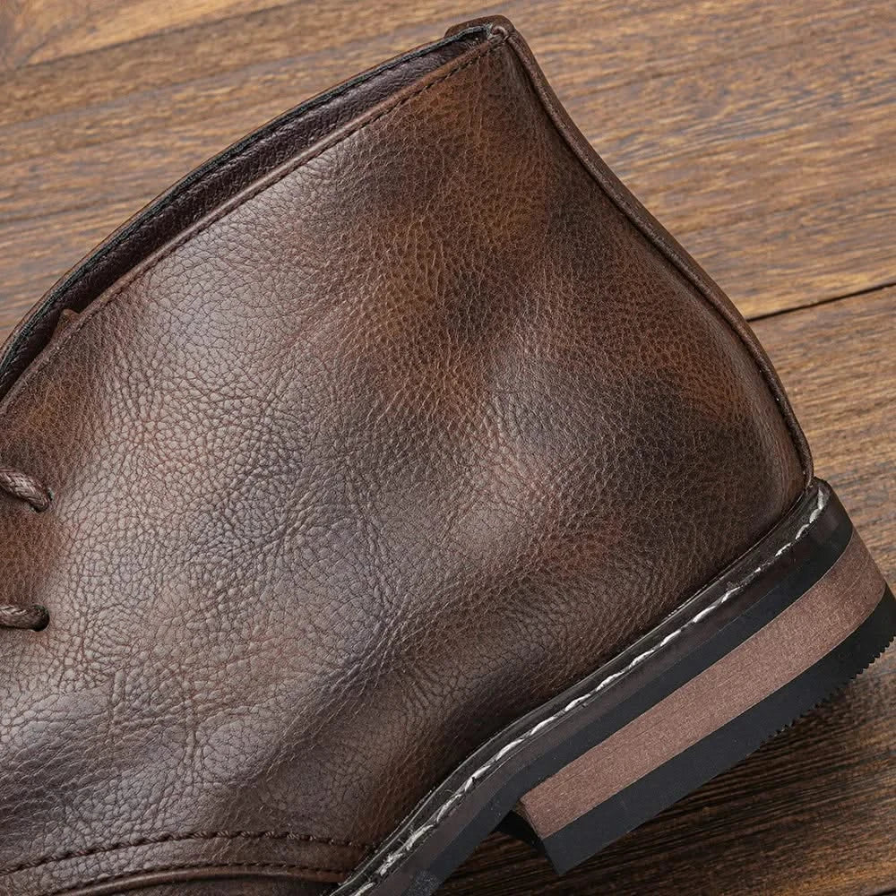 Brown grained leather chukka boot featuring a stitched welt, stacked block heel, and three-eyelet lace-up design.