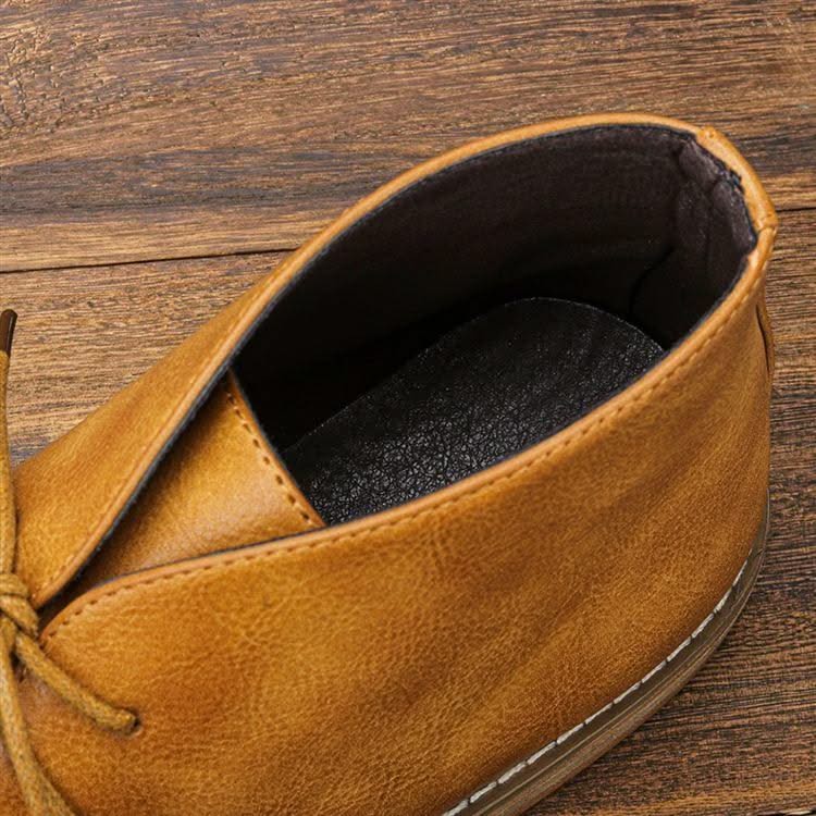 Tan grained leather chukka boot featuring a three-eyelet lace-up design, visible welt stitching, and a cushioned insole.
