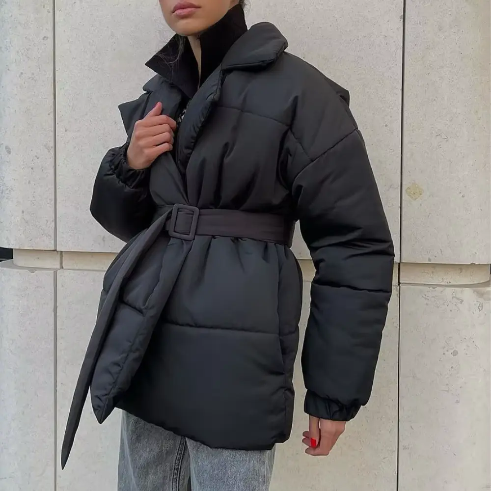 Black belted wrap puffer jacket with notch lapels, quilted channels, and elastic cuffs cinched at the waist.