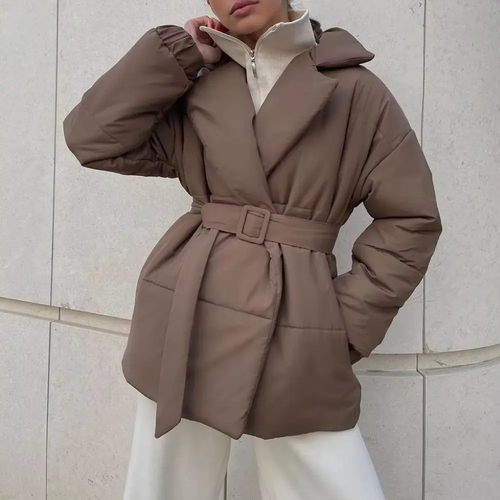 Brown belted wrap puffer jacket with notch lapels, quilted padding, and elastic cuffs worn over a zip-neck knit.