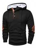 Black waffle knit pullover hoodie with a button placket, contrast drawstrings, and long sleeves on a white background.