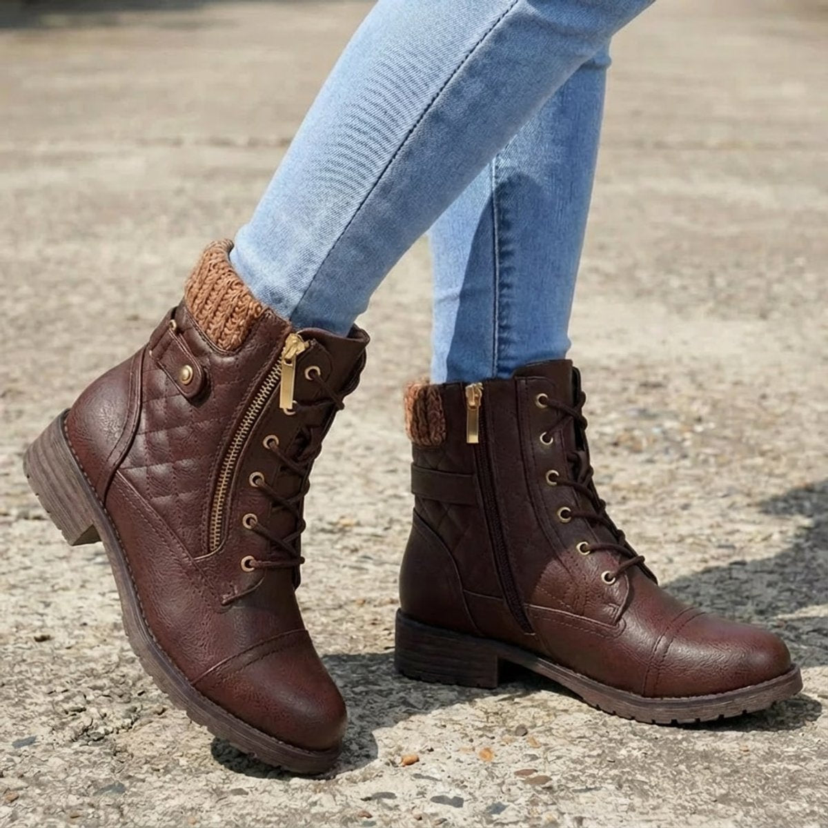 Brown quilted ankle boots with a ribbed knit cuff, side zip, lace-up front, and low block heel worn with blue jeans.