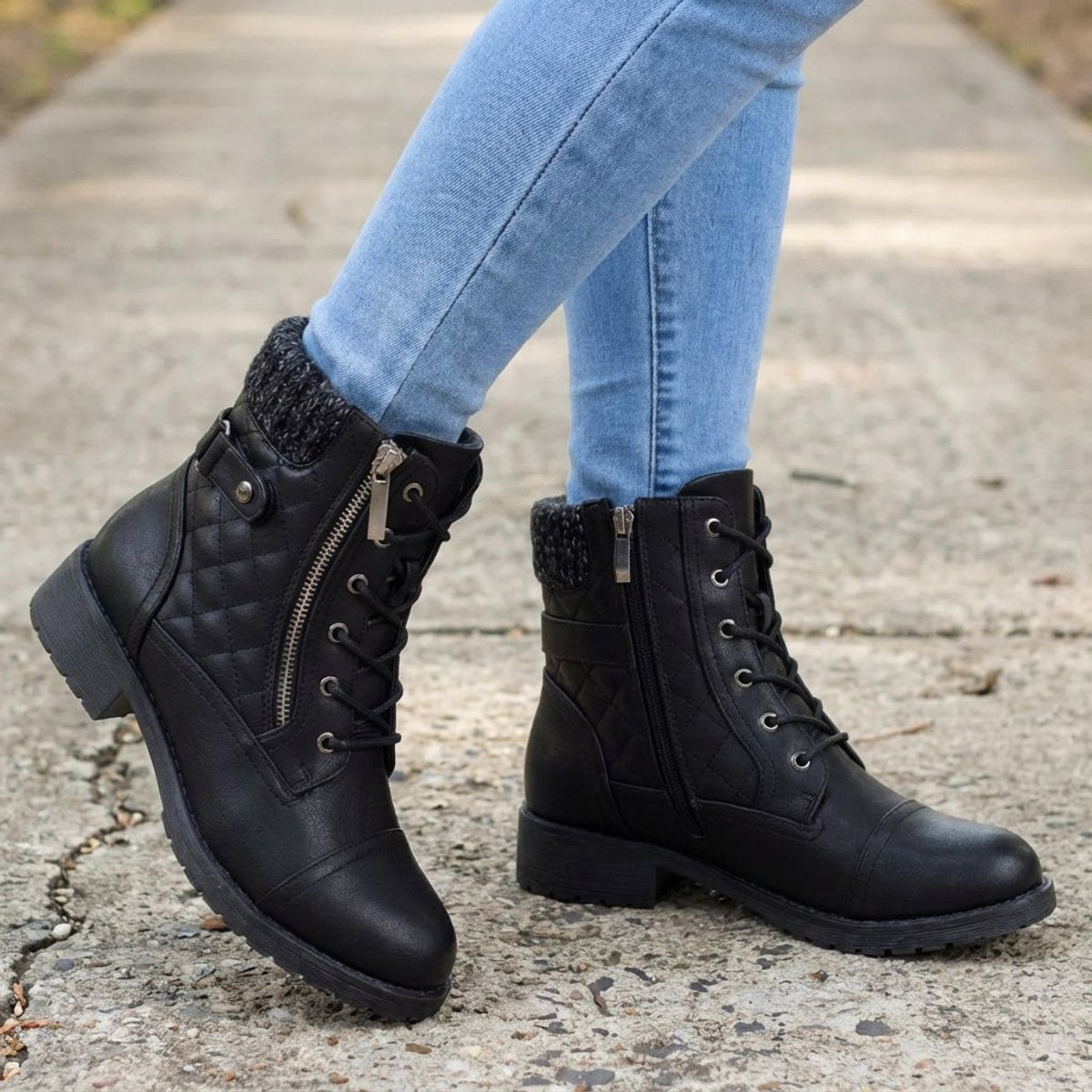 Black quilted ankle boots with ribbed knit cuffs, side zip closures, lace-up fronts, and low block heels worn with jeans.