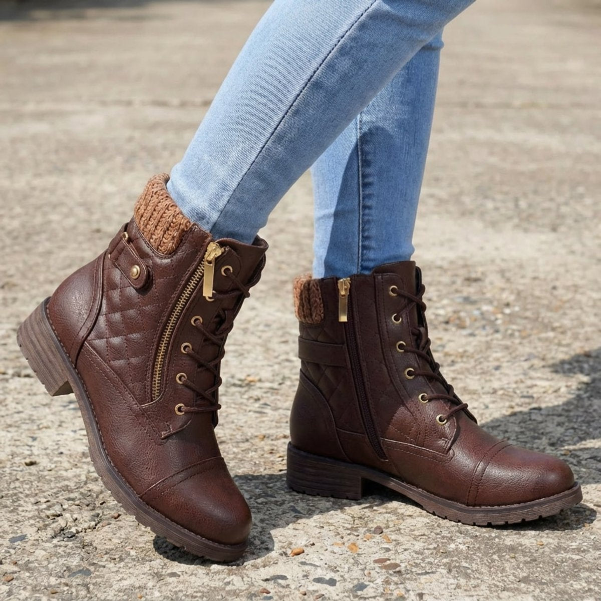 Brown quilted ankle boots with a ribbed knit cuff, side zip, lace-up front, and low block heel worn with blue jeans.