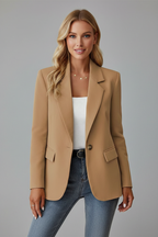 Camel tailored blazer with notched lapels, single-button closure, and structured shoulders worn over denim.