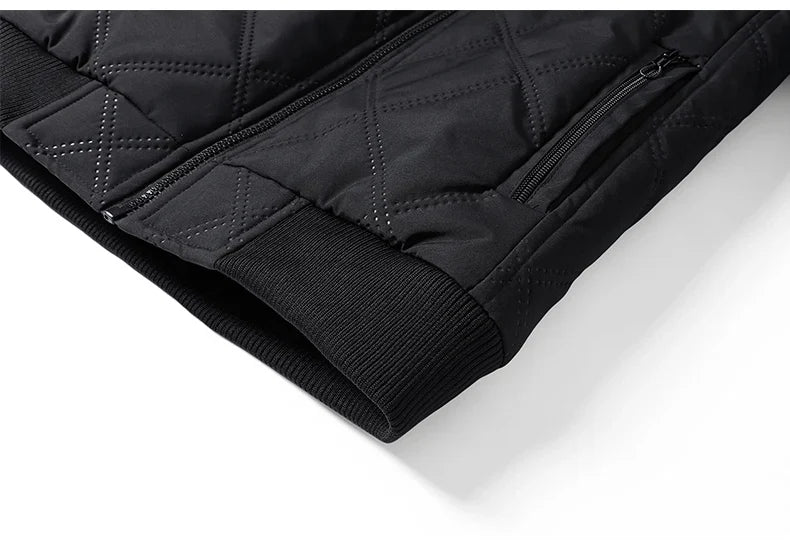 Close-up of the jacket's ribbed hem and quilted outer fabric showing premium construction.