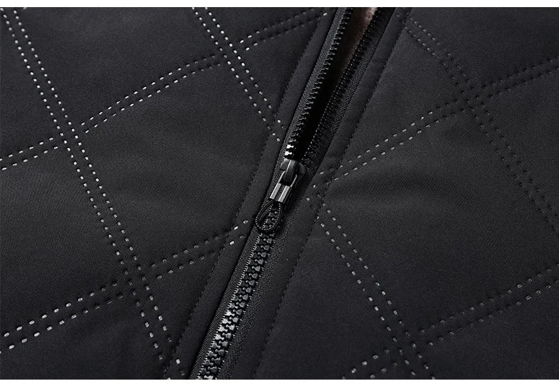 Close-up of the black diamond-quilted fabric and durable front zipper stitching.