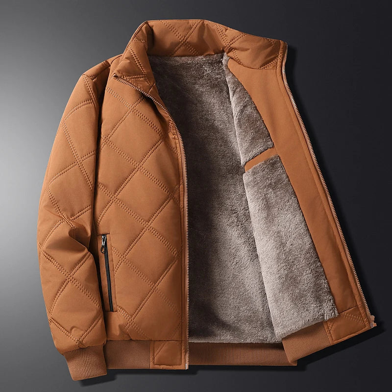 Men's brown quilted zip-up jacket with a soft fleece lining, stand collar, ribbed cuffs, and zip pockets displayed open.