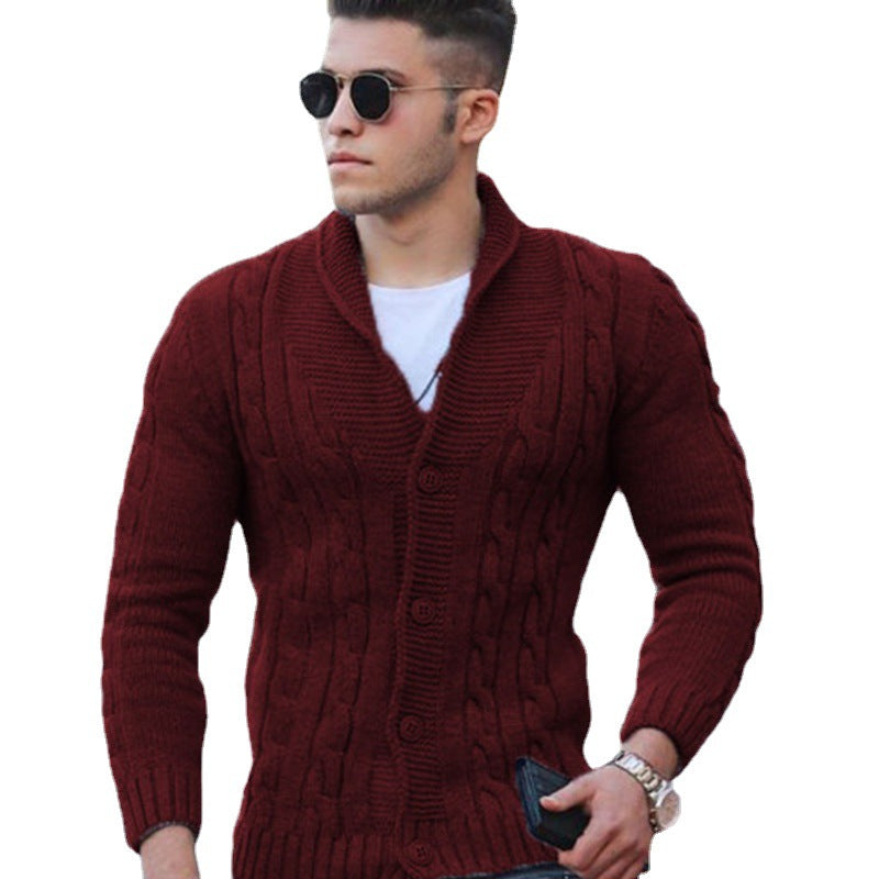 Burgundy cable knit shawl collar cardigan with a button-front closure and ribbed cuffs worn over a white tee.
