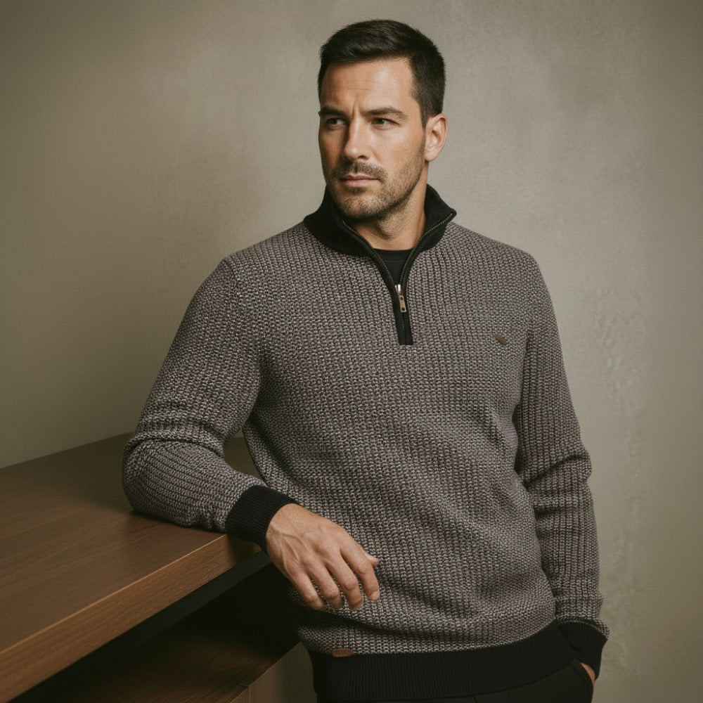 Grey birdseye knit quarter zip sweater with a stand collar, ribbed cuffs, and a regular fit in a textured wool blend.
