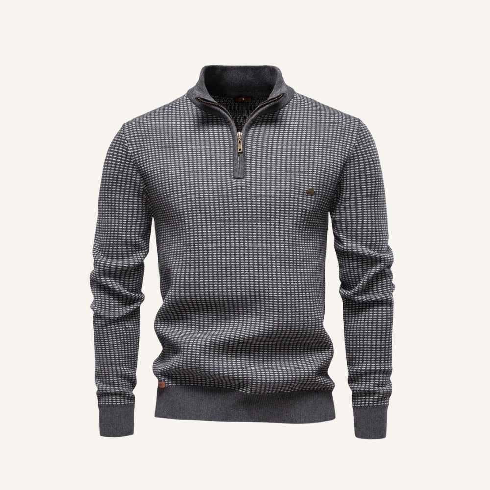 Grey birdseye knit quarter zip sweater with a stand collar, ribbed cuffs, and a regular fit.