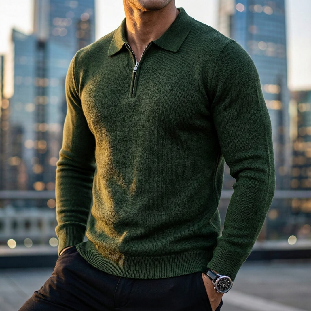 Forest green quarter-zip knit polo sweater with a ribbed collar, long sleeves, and ribbed hem, worn in a city setting.