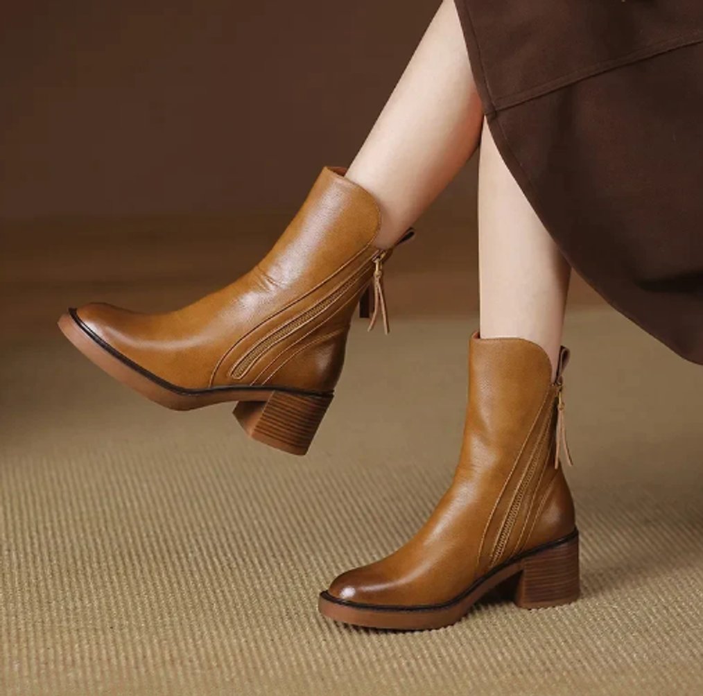 Tan grained leather ankle boots with side zips, stacked block heels, and knotted back tie details.