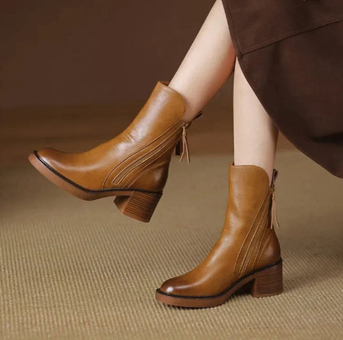 Tan grained leather ankle boots with side zips, stacked block heels, and knotted back tie details.