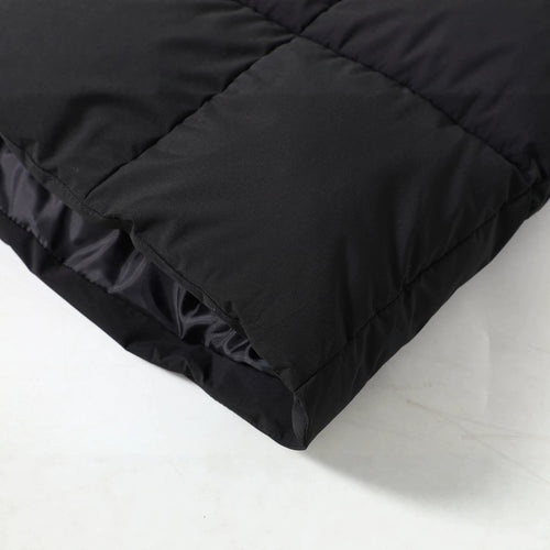 Close-up of the black Chevron-Quilted Longline Puffer Coat showing the chevron-quilted fabric and padded construction.