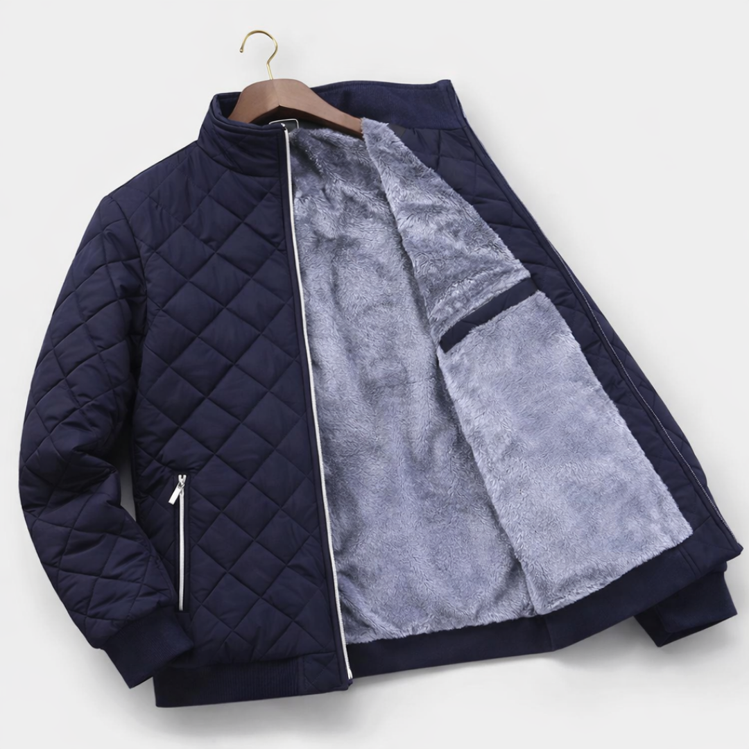 Navy diamond-quilted zip-up jacket displayed open, showcasing the soft fleece-lined interior and insulated construction.